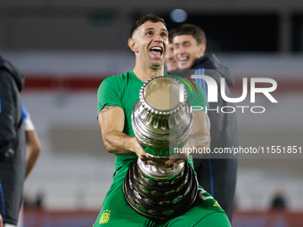 Emiliano Martinez of Argentina celebrates with the Copa America 2024 trophy after the FIFA World Cup 2026 Qualifier match between Argentina...