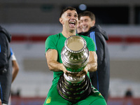 Emiliano Martinez of Argentina celebrates with the Copa America 2024 trophy after the FIFA World Cup 2026 Qualifier match between Argentina...