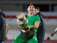 Emiliano Martinez of Argentina celebrates with the Copa America 2024 trophy after the FIFA World Cup 2026 Qualifier match between Argentina...