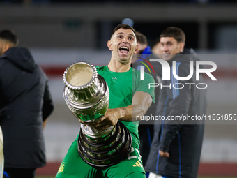 Emiliano Martinez of Argentina celebrates with the Copa America 2024 trophy after the FIFA World Cup 2026 Qualifier match between Argentina...