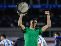 Emiliano Martinez of Argentina celebrates with the Copa America 2024 trophy after the FIFA World Cup 2026 Qualifier match between Argentina...