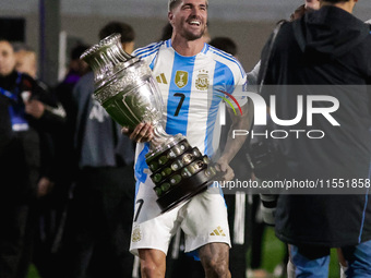 Rodrigo de Paul of Argentina celebrates with the Copa America 2024 trophy after the FIFA World Cup 2026 Qualifier match between Argentina an...