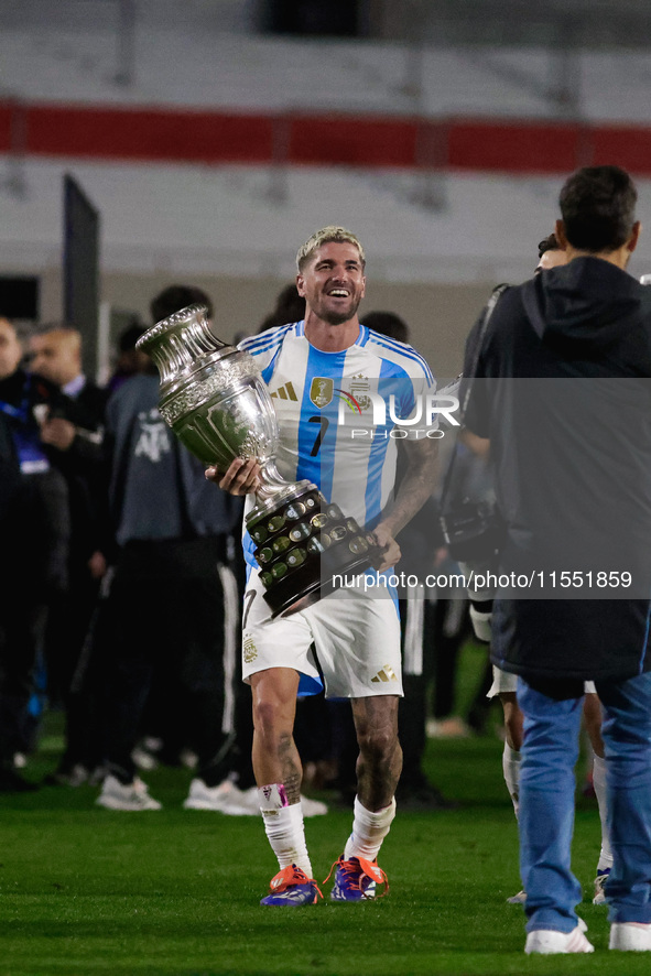 Rodrigo de Paul of Argentina celebrates with the Copa America 2024 trophy after the FIFA World Cup 2026 Qualifier match between Argentina an...