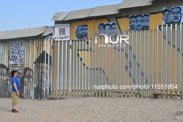 A man looks at a new interactive mural of deported veterans at the Playas de Tijuana beach border wall, ''The Deported Veterans Diaspora,''...