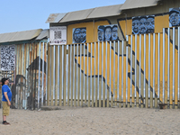 A man looks at a new interactive mural of deported veterans at the Playas de Tijuana beach border wall, ''The Deported Veterans Diaspora,''...