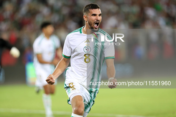 Houssem Eddine Aouar of Algeria celebrates after scoring a goal during the football match for the qualification of the African Cup of Nation...