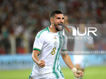 Houssem Eddine Aouar of Algeria celebrates after scoring a goal during the football match for the qualification of the African Cup of Nation...