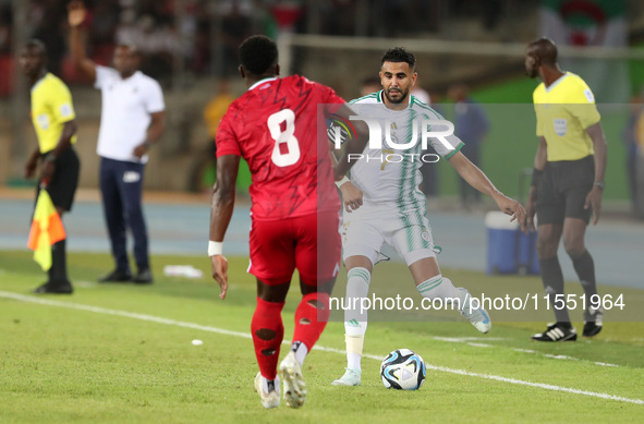 Riyad Karim Mahrez of Algeria competes with Jannick Buyla Sam of Equatorial Guinea during the African Cup of Nations (CAN 2025) qualificatio...