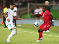 Riyad Karim Mahrez of Algeria competes with Basilio Ndong Owono of Equatorial Guinea during the African Cup of Nations (CAN 2025) qualificat...