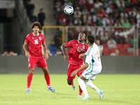 Riyad Karim Mahrez of Algeria competes with Basilio Ndong Owono of Guinea during the qualification match for the African Cup of Nations (CAN...