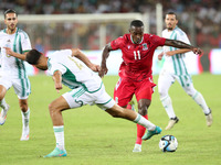 Mohamed Amine Tougai of Algeria competes with Basilio Ndong Owono of Equatorial Guinea during the qualification match for the African Cup of...