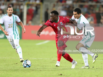 Aissa Mandi (R) of Algeria in action with Jannick Buyla Sam of Equatorial Guinea during the football match of the qualification of the Afric...