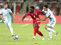 Aissa Mandi (R) of Algeria in action with Jannick Buyla Sam of Equatorial Guinea during the football match of the qualification of the Afric...