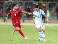 Houssem Eddine Aouar (right) of Algeria in action with Omar Mascarell Gonzales of Guinea during the football match of the qualification of t...