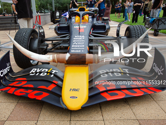 A Texas-themed F1 car outfitted with longhorn horns and ''slab'' wheels wows attendees at a private preview event for Red Bull's Houston Sho...