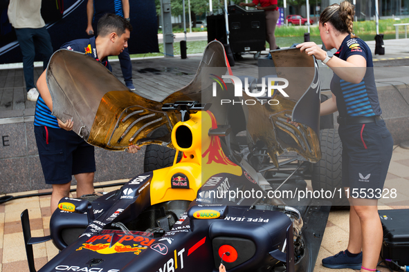 Red Bull engineers prepare the RB8 for engine revving at a private preview event for Red Bull's Houston Showrun in Houston, Texas, on Septem...