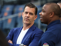 Former Mets general manager Brodie Van Wagenen stands on the field chatting with Rajai Davis during batting practice before the baseball gam...