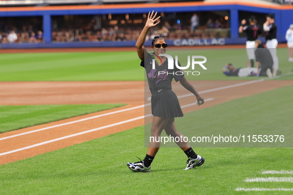 USA Olympic gymnast Jordan Chiles walks out on the field to throw out the ceremonial first pitch before the baseball game between the Cincin...