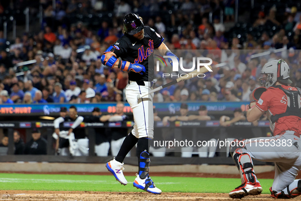 Jeff McNeil #1 of the New York Mets is hit by a pitch during the fifth inning of the baseball game against the Cincinnati Reds at Citi Field...