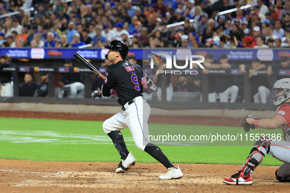 Brandon Nimmo #9 of the New York Mets singles during the seventh inning of the baseball game against the Cincinnati Reds at Citi Field in Co...