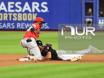 New York Mets Tyrone Taylor #15 steals second base during the ninth inning of the baseball game against the Cincinnati Reds at Citi Field in...