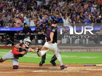 New York Mets Pete Alonso #20 beats the throw to score as Reds catcher Tyler Stephenson #37 tries to make the tag during the sixth inning of...