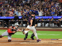 New York Mets Pete Alonso #20 beats the throw to score as Reds catcher Tyler Stephenson #37 tries to make the tag during the sixth inning of...