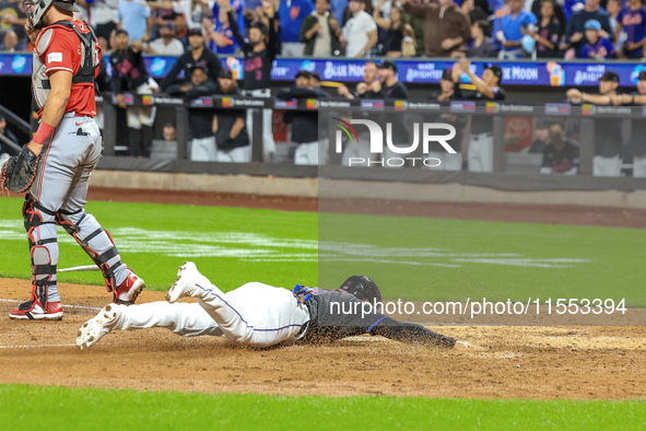 New York Mets' Jose Iglesias #11 scores from 2B during the sixth inning of the baseball game against the Cincinnati Reds at Citi Field in Co...