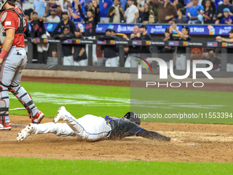 New York Mets' Jose Iglesias #11 scores from 2B during the sixth inning of the baseball game against the Cincinnati Reds at Citi Field in Co...