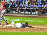 New York Mets' Jose Iglesias #11 scores from 2B during the sixth inning of the baseball game against the Cincinnati Reds at Citi Field in Co...