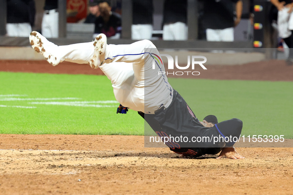 New York Mets' Jose Iglesias #11 flips himself up after scoring during the sixth inning of the baseball game against the Cincinnati Reds at...