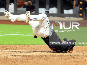 New York Mets' Jose Iglesias #11 flips himself up after scoring during the sixth inning of the baseball game against the Cincinnati Reds at...