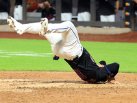 New York Mets' Jose Iglesias #11 flips himself up after scoring during the sixth inning of the baseball game against the Cincinnati Reds at...