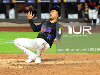 New York Mets' Jose Iglesias #11 flips himself up after scoring during the sixth inning of the baseball game against the Cincinnati Reds at...