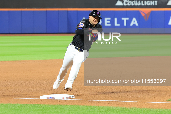 New York Mets' Jose Iglesias #11 scores from 2B during the sixth inning of the baseball game against the Cincinnati Reds at Citi Field in Co...