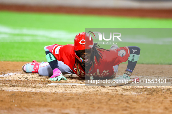 Elly De La Cruz #44 of the Cincinnati Reds hits the ground after avoiding a pitch during the ninth inning of the baseball game against the N...