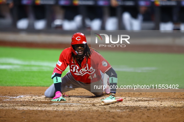 Elly De La Cruz #44 of the Cincinnati Reds hits the ground after avoiding a pitch during the ninth inning of the baseball game against the N...