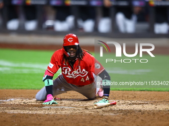 Elly De La Cruz #44 of the Cincinnati Reds hits the ground after avoiding a pitch during the ninth inning of the baseball game against the N...