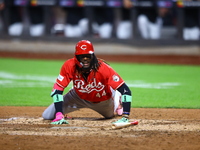 Elly De La Cruz #44 of the Cincinnati Reds hits the ground after avoiding a pitch during the ninth inning of the baseball game against the N...