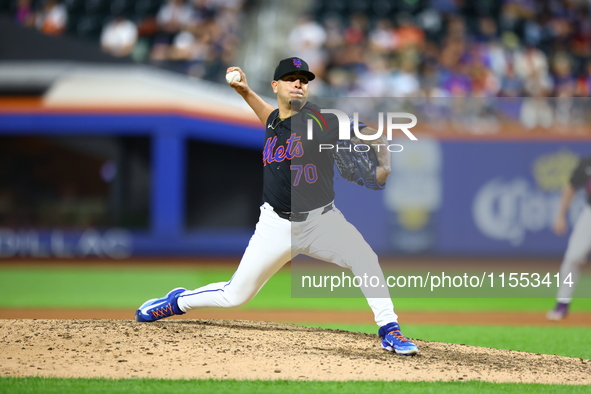 New York Mets relief pitcher Jose Butto #70 throws during the tenth inning of the baseball game against the Cincinnati Reds at Citi Field in...