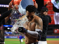 New York Mets' Mark Vientos #27 receives a Gatorade and water bath from teammates after his 10th inning game-winning home run lifts the Mets...