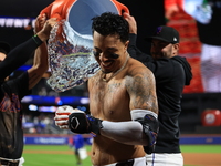 New York Mets' Mark Vientos #27 receives a Gatorade and water bath from teammates after his 10th inning game-winning home run lifts the Mets...