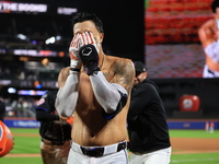 New York Mets' Mark Vientos #27 receives a Gatorade and water bath from teammates after his 10th inning game-winning home run lifts the Mets...