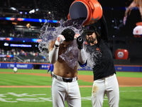 New York Mets' Mark Vientos #27 receives a Gatorade and water bath from teammates after his 10th inning game-winning home run lifts the Mets...