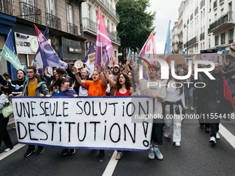 People march holding a banner that reads, 'A single solution destitution', during a protest after the appointment of a right-wing prime mini...