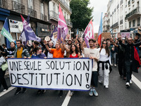 People march holding a banner that reads, 'A single solution destitution', during a protest after the appointment of a right-wing prime mini...