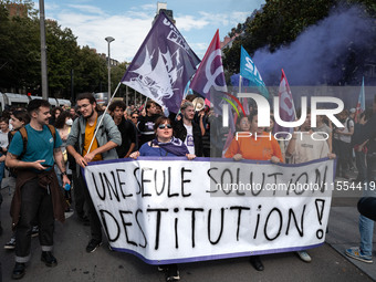 People march holding a banner that reads, 'A single solution destitution', during a protest after the appointment of a right-wing prime mini...