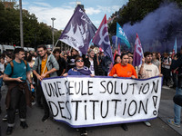 People march holding a banner that reads, 'A single solution destitution', during a protest after the appointment of a right-wing prime mini...