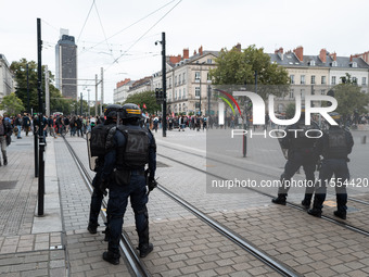 Protestors face the police during a protest after the appointment of a right-wing prime minister two days ago following July snap elections,...