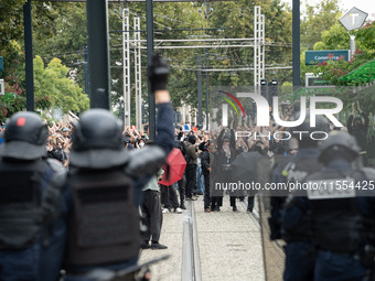 Protestors face the police during a protest after the appointment of a right-wing prime minister two days ago following July snap elections,...